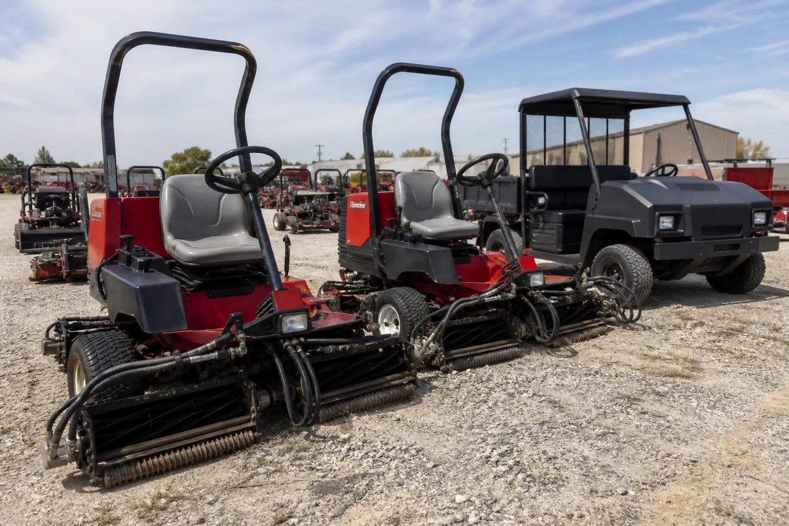 Used turf equipment staged in a maintenance yard
